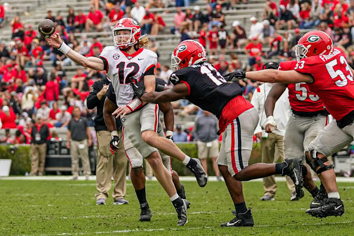 Apr 16, 2022; Athens, Georgia, USA; Georgia Bulldogs quarterback Brock Vandagriff (12) passes under pressure from defensive lineman Mykel Williams (13) during the Georgia Bulldogs Spring Game at Sanford Stadium. Credit: Dale Zanine-USA TODAY Sports